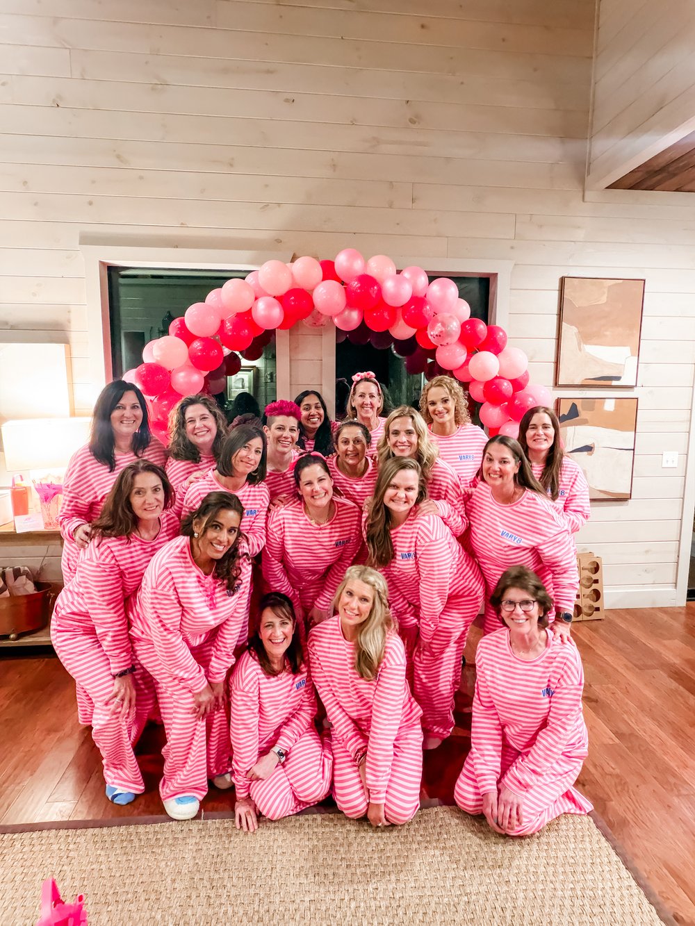 Vary-8 women in matching pink striped pajamas at retreat