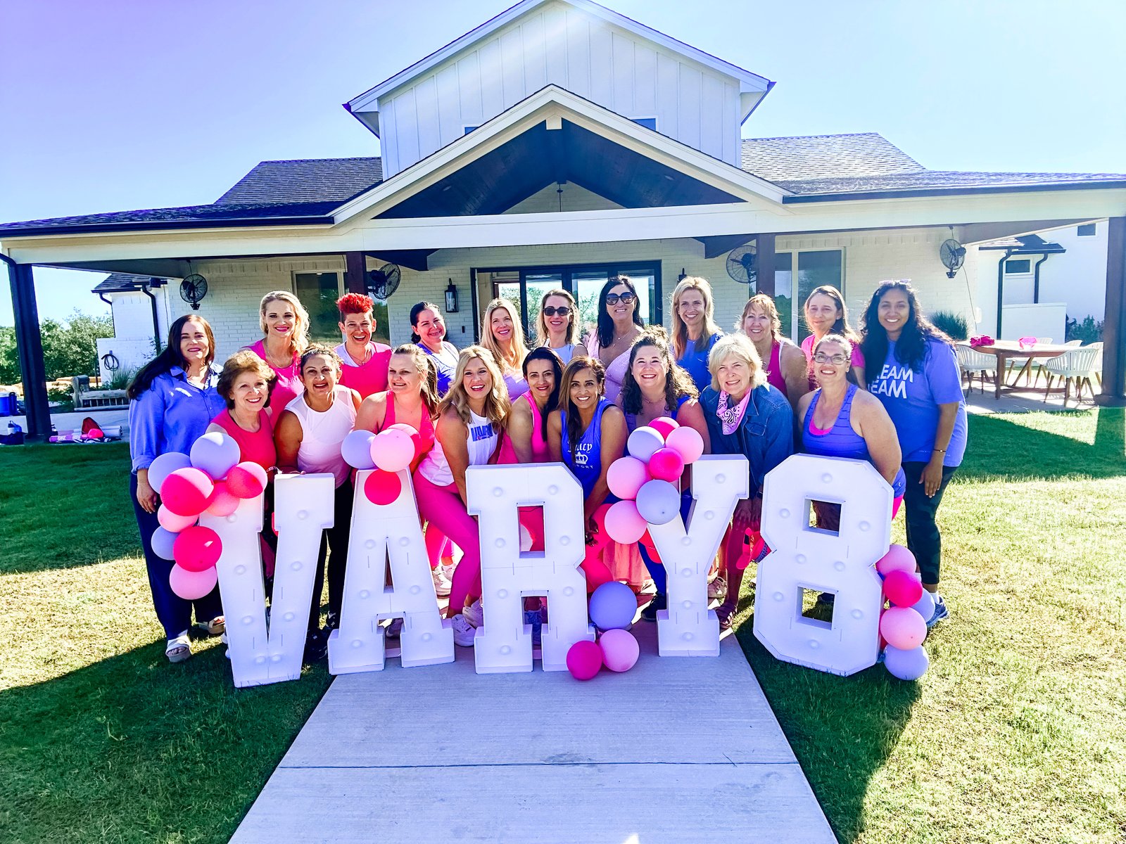 Vary-8 community group photo with marquee letters