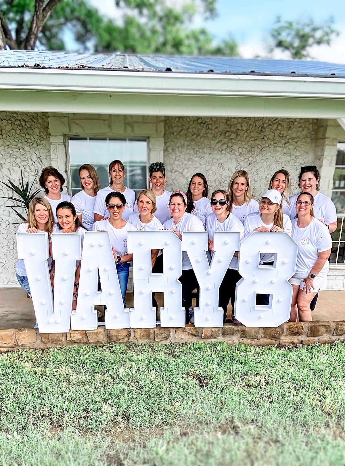 Vary-8 retreat group photo in branded white tees